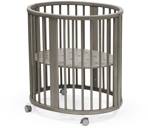 Stokke Sleepi Mini, Hazy Grey - Ovales Kinderbett für 0-6 Monate - Höhenverstellbares Gestell, feststellbare Schwenkräder, perforierte Matratzenauflage für Luftzirkulation