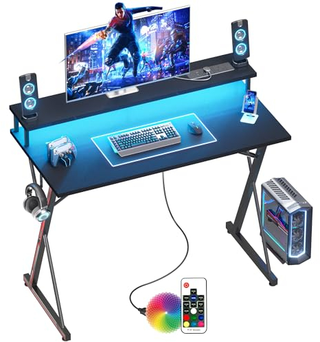 BEXEVUE Escritorio Gaming Regleta Enchufes LED - 100x50cm Escritorio Gamer Ergonómico, Grande Soporte Monitor, Mesa Moderna, Marco X, Gancho Auriculare, Estudio Juego Trabajo Dormitorio Oficina Hogar