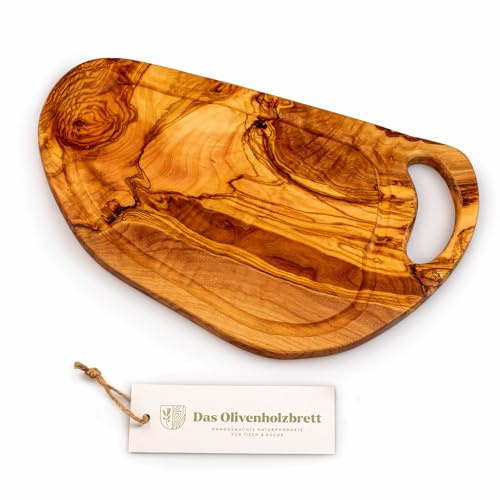 DAS OLIVENHOLZBRETT® / Olivenholz Schneidebrett mit Saftrille/Servierbrett/Steakbrett/Henkel/Naturschnitt- und Form - kann Rinde am Rand haben 30-34cm lang / 15-17cm breit