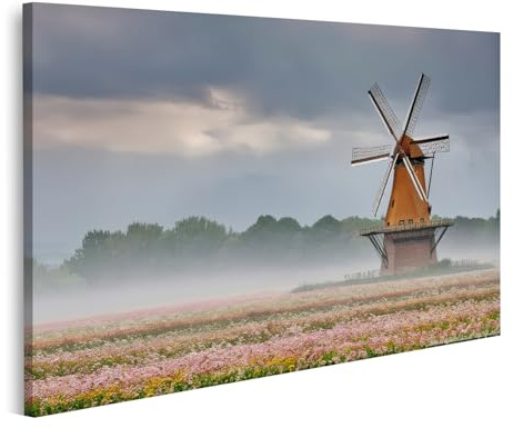 islandburner Bild auf Leinwand Windmühle im nebligen Morgen Blumenfelder im Abstand rosa Blüten unter bewölktem Himmel Bilder Wandbilder Poster