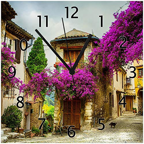 Wallario Design-Wanduhr Malerische Stadt in der Provence mit bunten Blumen aus Glas, Motiv-Uhr Größe 30 x 30 cm, Schwarze Zeiger