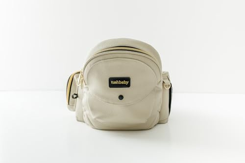 Tushbaby Marsupio per neonati e bambini (crema), certificato di sicurezza, lavabile in lavatrice, supporto per una mano con tasche multiple, vita 58,4 - 111,8 cm, può contenere bambini da 0 a 3 anni