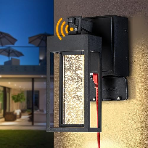 ALOADECOR 1 Light LED Modern Matte Black Dusk to Dawn Sensor Outdoor Wall Lantern Coach Sconces with Seed Glass and Built-in 2 GFCI Outlets Exterior Wall Mount Light for Garden Patio Front Door