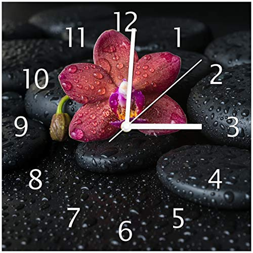 Wallario Design-Wanduhr Orchideen-Blüte auf schwarzen Steinen, benetzt mit Wasser-Tropfen aus Glas, Motiv-Uhr Größe 30 x 30 cm, weiße Zeiger