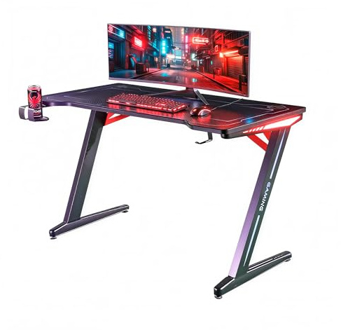 Unicview Escritorio Gaming 140 cm x 60 cm, Mesa para Ordenador Consola PS5, Xbox Series, pies de Acero, RGB LED, Base de alfombras, Rejilla para Recoger Cables
