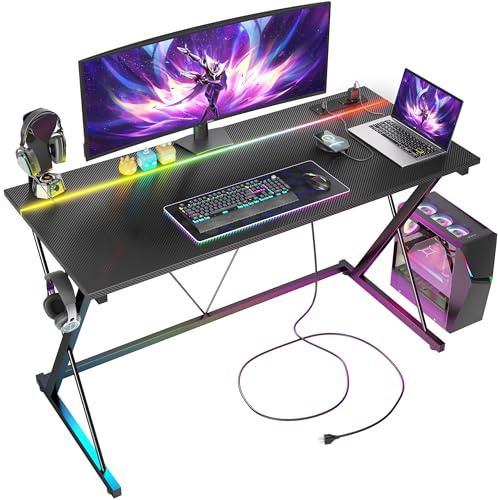 BEXEVUE Gaming Desk with LED Power Strip, 120x50 cm Computer Gamer Desk, 2 Outlets, USB and Type-C Ports, Modern X-Frame Design, Headphone Hook, Carbon Fiber Black