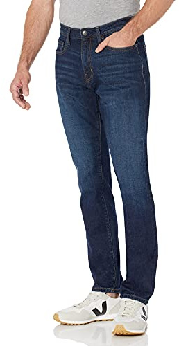 Amazon Essentials Vaqueros elásticos, Corte Holgado (Disponibles en Tallas Grandes) - Colores interrumpidos Hombre, Lavado Índigo, 52W / 30L