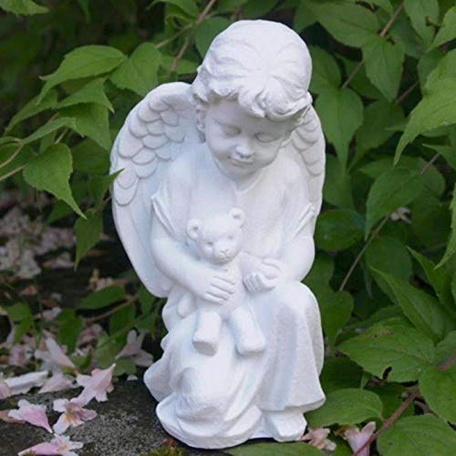 Trauer-Shop Kleiner Engel mit Trost Teddy im Arm haltend.