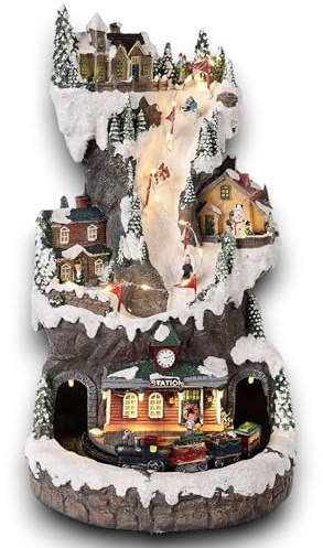 Villaggio di Natale innevato Verticale con Pista da sci, con stazione treno in movimento su binari, paesaggio con Luci LED e Musica Babbo Scenario Natalizio Parco sciistico Giochi Carillon 21x21x37cm