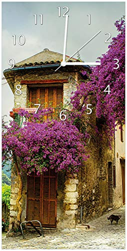 Wallario Design-Wanduhr Malerische Stadt in der Provence mit bunten Blumen aus Glas, Motiv-Uhr Größe 30 x 60 cm, weiße Zeiger